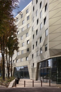 Die Metallfassade mit den quadratischen Fenstern verleiht dem Gebäude ein zukunftsweisendes Erscheinungsbild, das sich in seinem energetischen Konzept wiederfinden lässt.  